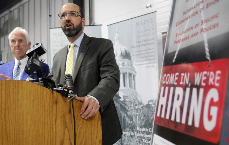 Maine Development Foundation President Yellow Light Breen, at lectern, and Maine State Chamber of Commerce President Dana Connors discuss a report on recruiting immigrants Thursday in Augusta. They called for expanding efforts to help them integrate into society and the workplace.