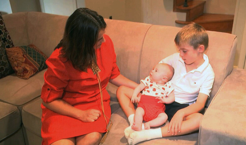 Sarah Gray relaxes with her son Callum, 6, and infant daughter, Jocelyn, at home in Washington. Callum's identical twin, Thomas, died when he was 6 days old and the family donated Thomas' eyes, liver and umbilical cord blood for medical research.