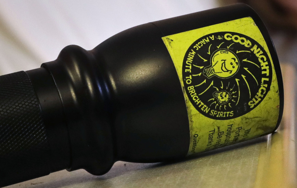 A flashlight with a "Good Night Lights" sticker rests on a table in 13-year-old Olivia Stephenson's hospital room.