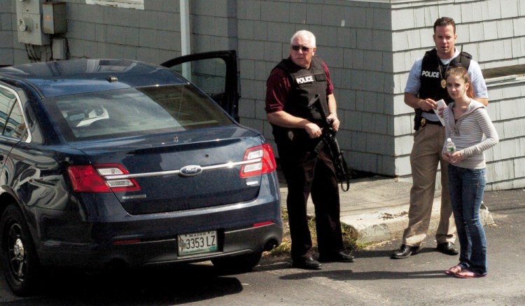 Waterville Police Chief Joe Massey, left, and officer Damon Lefferts interview a woman who is reportedly a friend of a man who was assaulted and injured at 11 Union St. on Thursday. Zachary Larrabee, 31, who lives on College Avenue, was arrested and charged with assault and criminal threatening later Thursday.