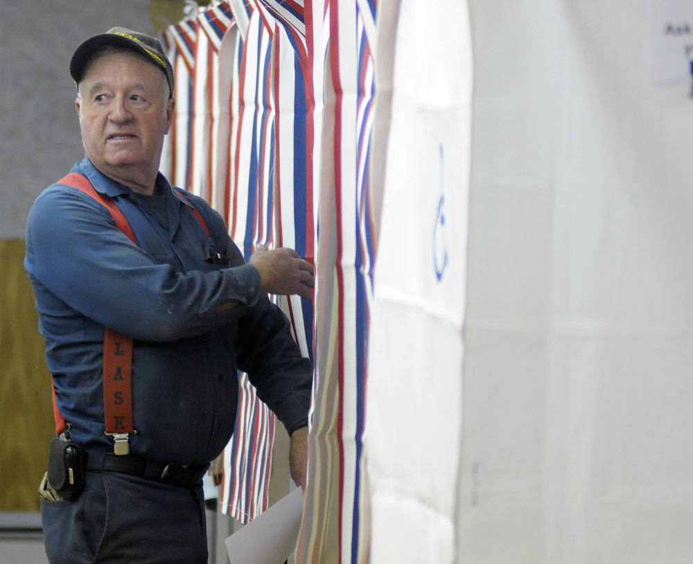 Gregory Larrabee heads into the polls June 14 to vote in Litchfield, where voters have twice rejected the school district budget.