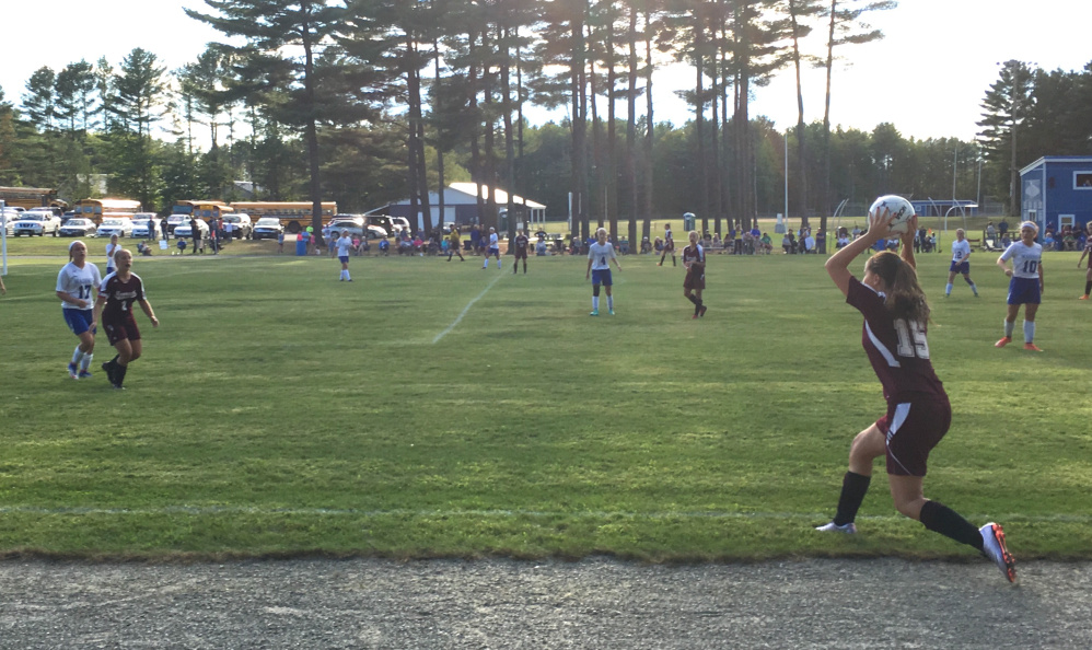 Monmouth's Kayla Brooks, right, takes a throw-in as Haley Fletcher and Madison's Shelby Belanger battle for position during a Mountain Valley Conference girls soccer game Friday afternoon.