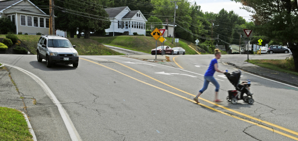 A woman pushes a baby stroller Thursday across Townsend Road near the intersection with Northern Avenue, where a $1.2 million construction project is set to begin this fall.