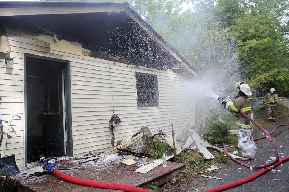 Firefighters extinguish a blaze Wednesday that heavily damaged a Mount Vernon home on Barbioni Lane, a private road near 402 Belgrade Road.