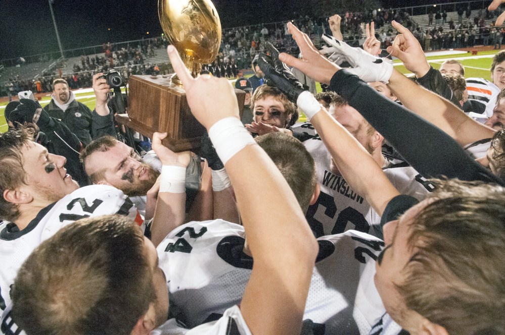 The Winslow football team celebrates after beating Yarmouth in the Class C state title game last season at Fitzpatrick Stadium in Portland.
