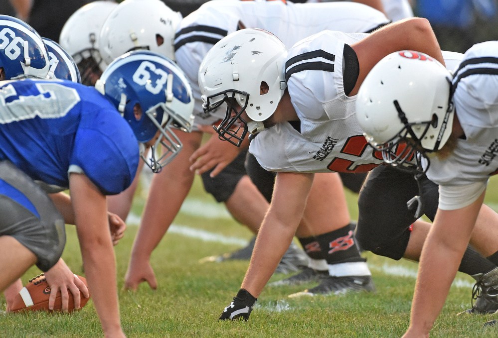 Skowhegan two-way tackle Owen Boardman, center, lines up during a game against Lawrence last Friday.