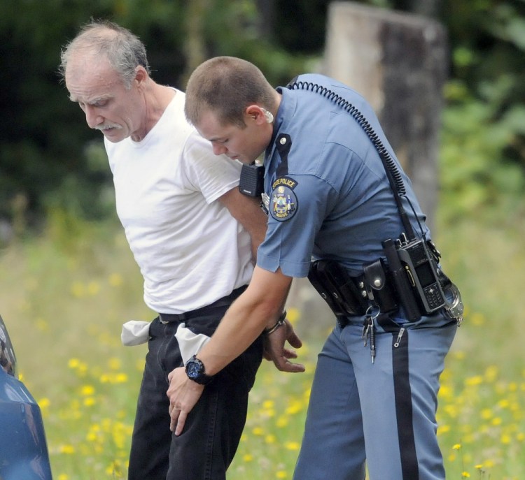 Douglas Burl, 54, is arrested Thursday by Trooper Seth Allen after Burl allegedly fired a .22-caliber rifle at a man outside his Chelsea residence. Burl was charged with reckless conduct with a dangerous weapon and criminal threatening with a dangerous weapon by troopers after the 10 a.m. incident. No injuries were reported.