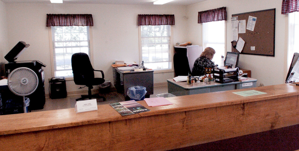 Unity Town Clerk Samantha Mank works Monday inside the town office, where $5,000 worth of new heat pumps will be installed following voter approval at a special town meeting Wednesday.