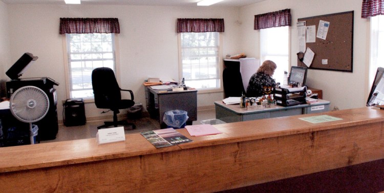 Unity Town Clerk Samantha Mank works Monday inside the town office, where $5,000 worth of new heat pumps will be installed following voter approval at a special town meeting Wednesday.