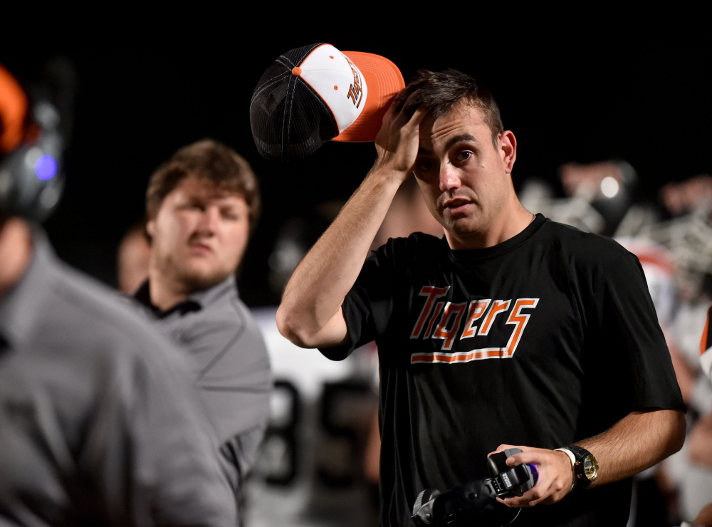 Jordan Hersom, an assistant coach at Gardiner Area High School, wipes his brow during a game against Skowhegan last Friday in Skowhegan.