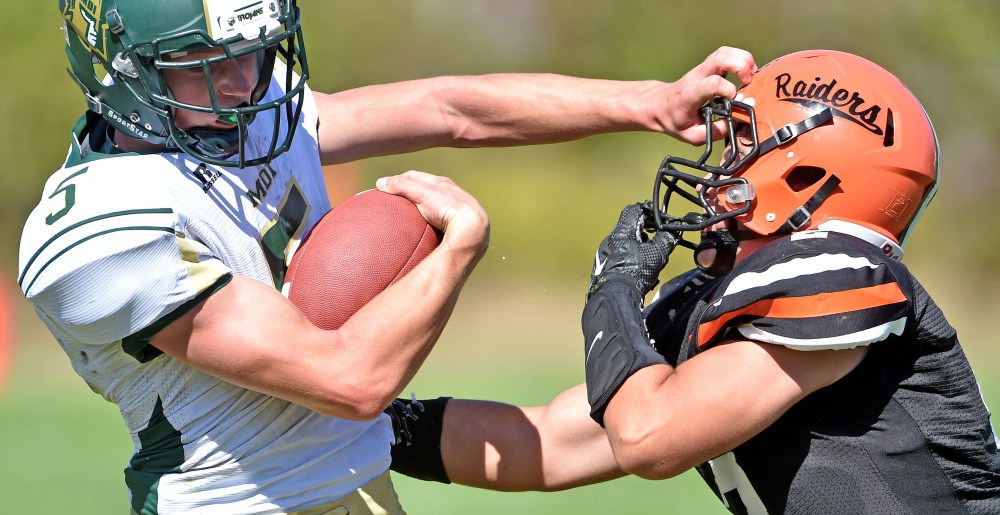 Staff photo by Michael G. Seamans 
 Winslow's Patrick Hopkins, right, defends Mount Desert Island's Colby Lee (5) on Saturday in Winslow.