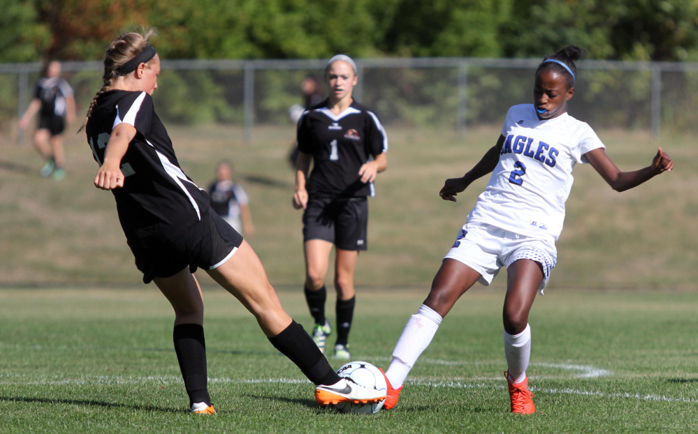 Winslow's Paige Trask, left, and Erskine's Haymanot Maynard arrive to the ball at the same time during first-half action Saturday in South China.