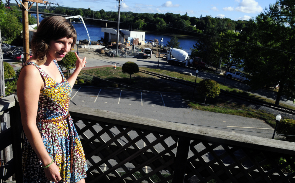 Community Outreach Director Tyler Kidder talks about views of the Kennebec River as she stands on the back deck of the new GrowSmart Maine office on Thursday in Gardiner.
