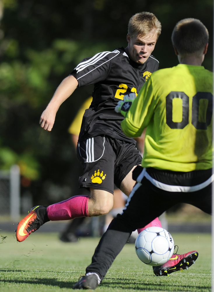Maranacook senior striker Sam Wilkinson fires a shot past Erskine sophomore goalie David McGraw during a Class B game Tuesday in South China.