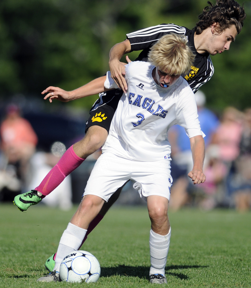Maranacook senior defender Dennis Chiappetta collides with Erskine's Caleb Tyler during a Class B game Tuesday in South China.