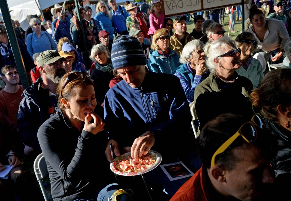 People taste different sample of apples as John Bunker speaks during an apple tasting event at the Common Ground Country Fair in Unity on Saturday. Bunker writes the Fedco Tree catalog and is an expert in apple identification.