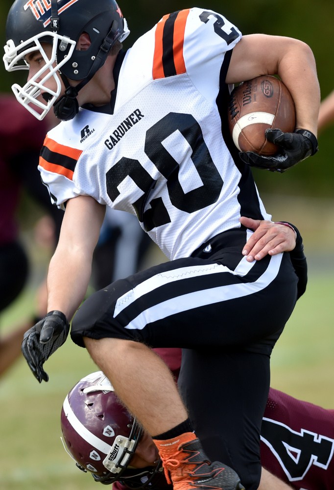 Gardiner sophomore Nate Malinowski runs over Nokomis defender Isaac Thibodeau during a Pine Tree Conference Class B game last Saturday afternoon in Newport.