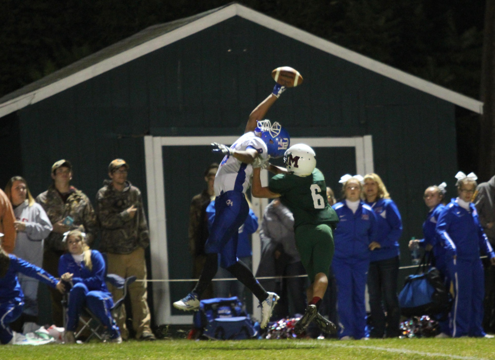 Oak Hill High School's Darryn Bailey is unable to come down with a pass thrown by quaterback Matthew Strout while being defended by Winthrop/Monmouth's Cameron Gaghan during first-half action on Friday night in Winthrop.