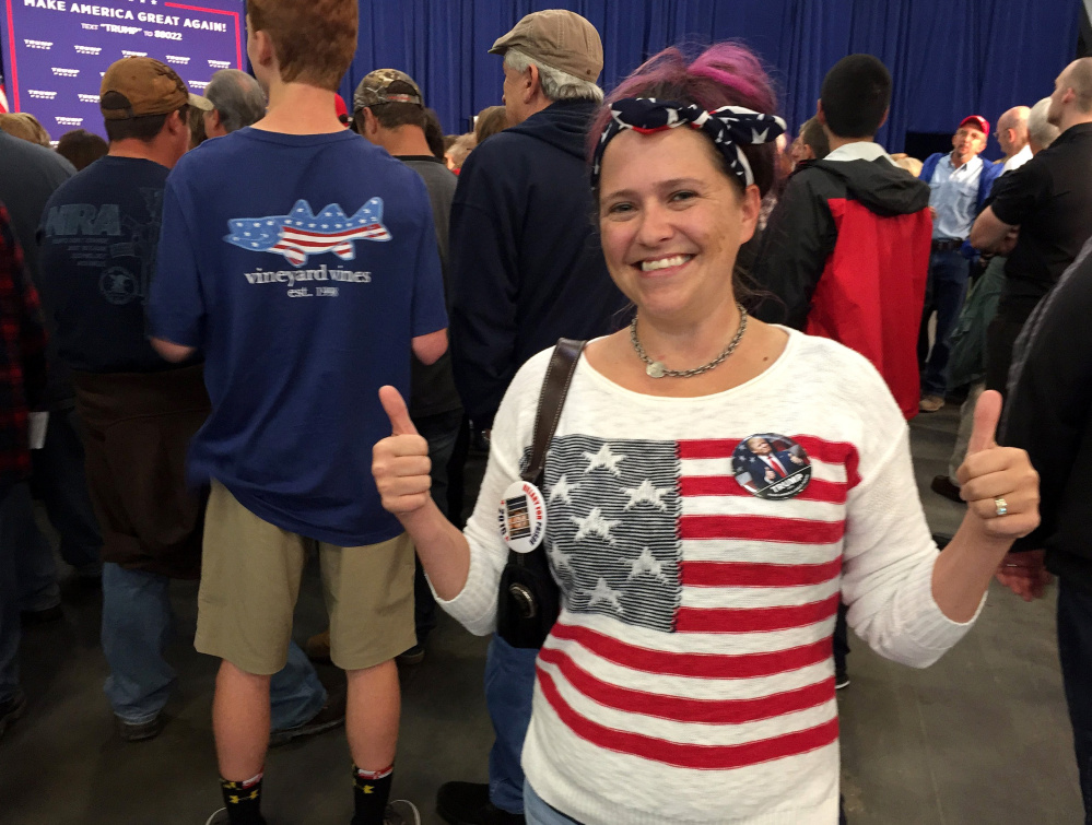 Kelly Hammer signals her support for Donald Trump at a Mike Pence rally in York, Pa.