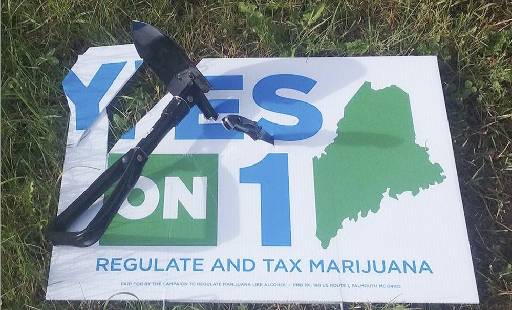 A trench shovel was driven into this sign in the town of Brooks. Police and political activists say sign vandalism doesn't appear any worse than usual, despite a combative election season.