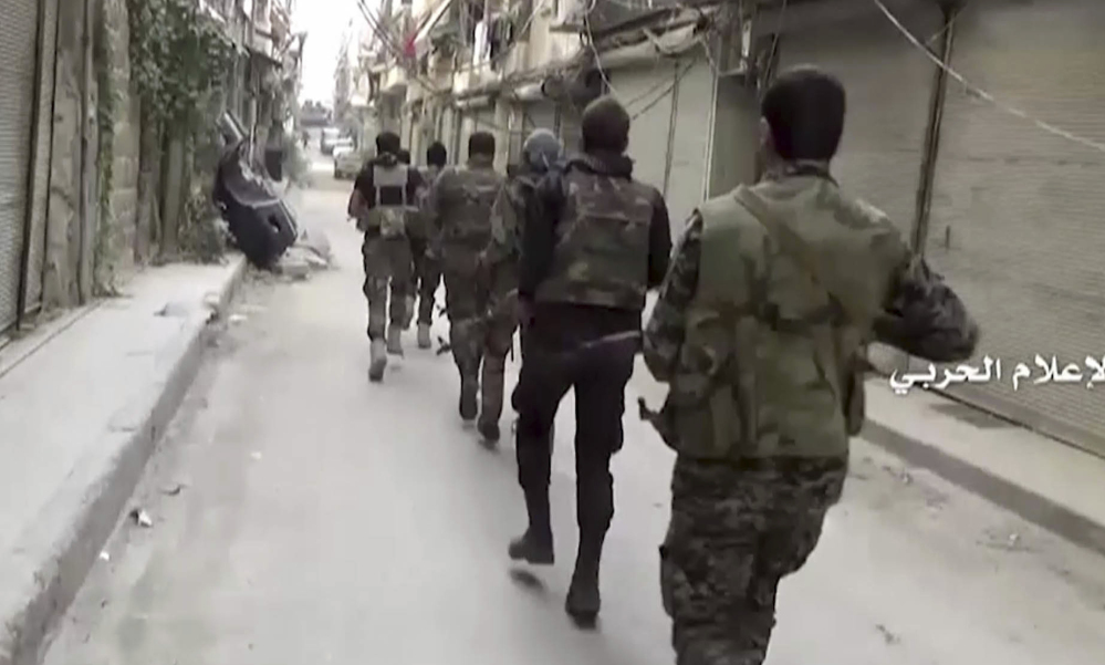 Government troops patrol Tuesday in Aleppo, Syria. A U.N. Security Council resolution calls for grounding aircraft including Russia's over the hard-hit city.