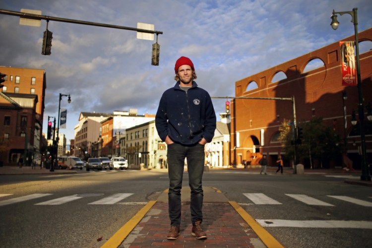 Asher Woodworth was arrested Monday after he adorned himself with tree branches and slowly walked across this intersection at Congress and High streets. He says his performance art was meant to call attention to the contrast between the fast pace of an urban space with the slowness and magic of nature.