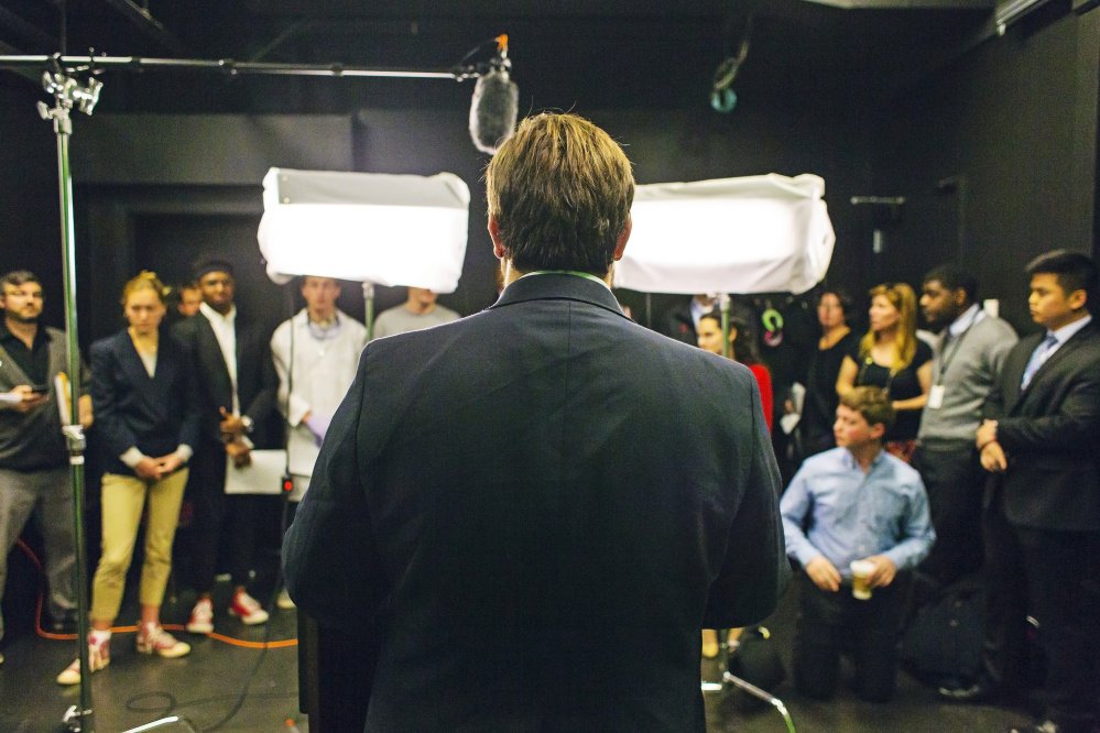 Student Gabriel Nott, playing the part of a presidential candidate, fields questions after making a mock televised address about a national crisis. More than a dozen classes on campus are assigned some task tied to the campaign exercise.