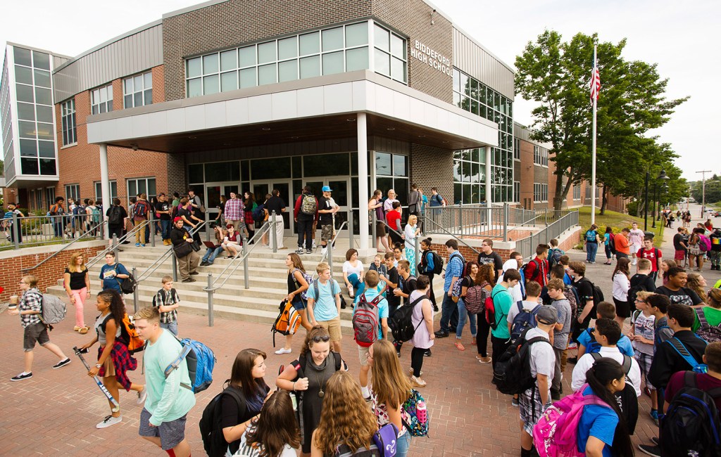 Students hang around outside Biddeford High School waiting for school to begin. Biddeford is one of many Maine schools to push the start of classes an hour later.