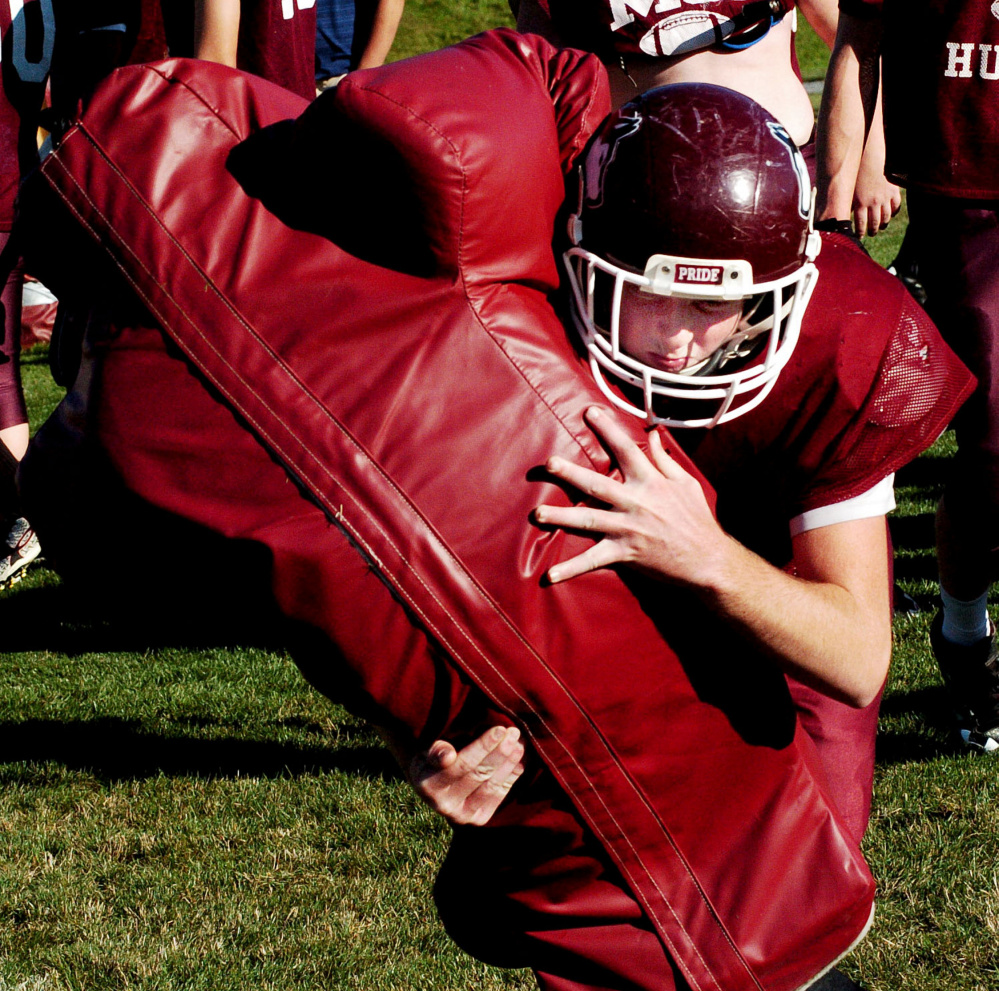 MCI senior Aaron Noonan hits the sled during practice in Pittsfield on Wednesday.