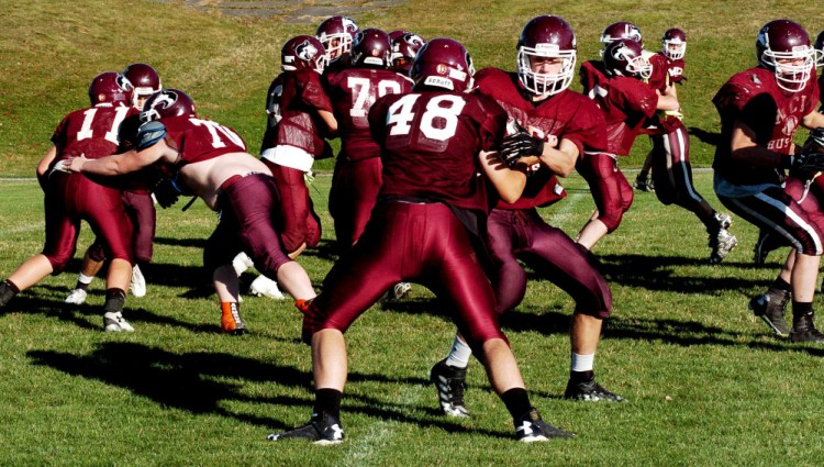 Members of the MCI offensive line work on blocking during practice in Pittsfield on Wednesday.