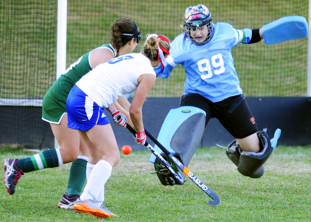 Oak Hill's Zoe Buteau, center, shoots and scores the game-winner between Winthrop defender Megan Chamberland, left, and goalie Corinna Coulton on Wednesday.