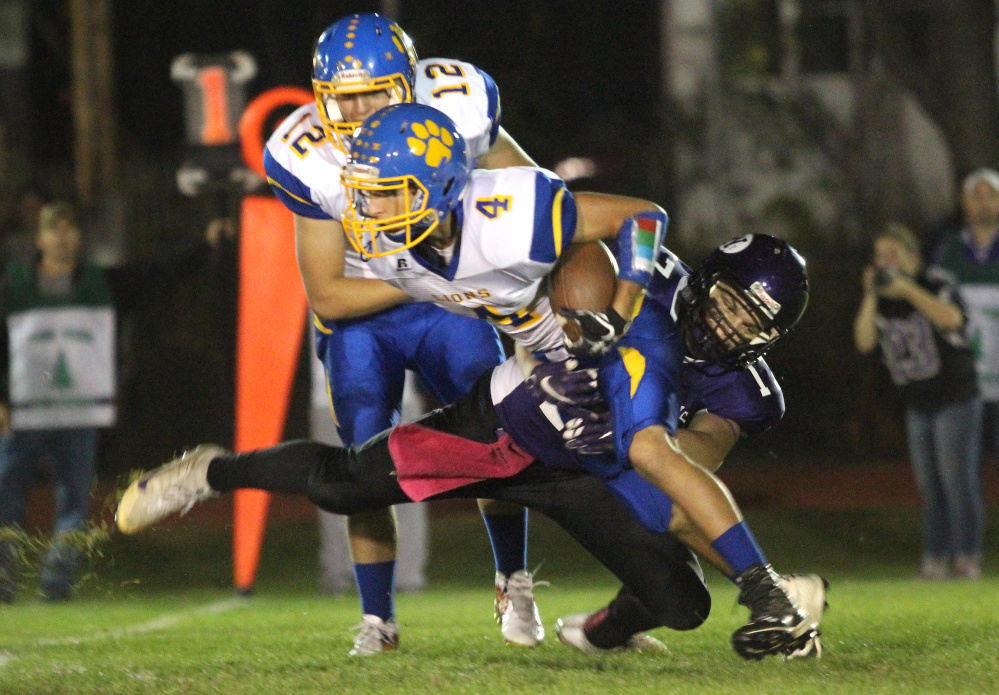 Waterville Senior High School's Cooper Hart tackles Belfast's Stan Sturgis in the backfield for a loss during first-half action Friday night in Waterville.