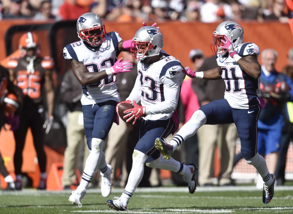 Patriots strong safety Patrick Chung celebrates an interception against the Cleveland Browns with Devin McCourty, left, and Jonathan Jones, 31, in the second half Sunday at Cleveland. Associated Press/David Richard