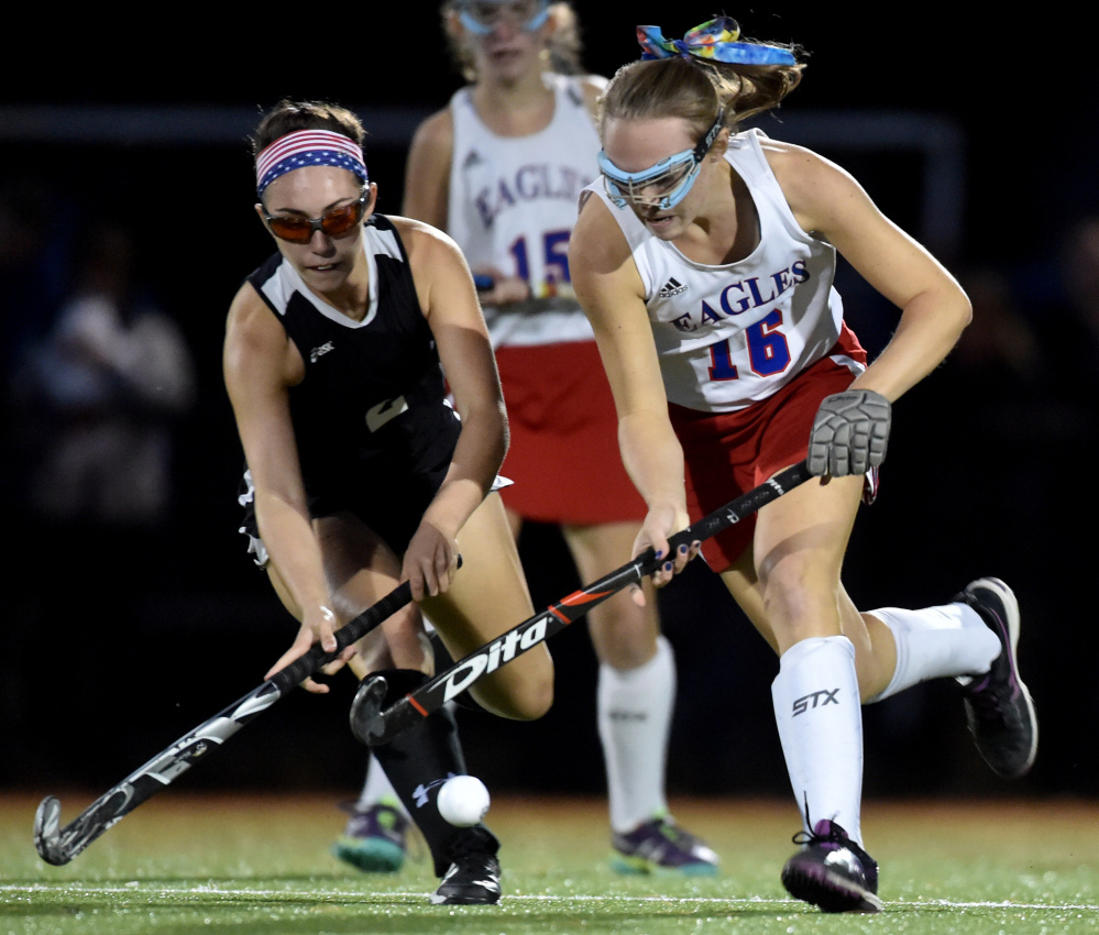Skowhegan's Maliea Kelso, left, battles for the ball with Messalonskee's Autumn Littlefield during a Kennebec Valley Athletic Conference Class A game Tuesday night at Thomas College.