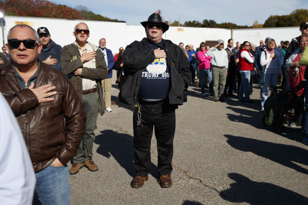 Supporters of Republican presidential candidate Donald Trump stand for the "Pledge of Allegiance" during a campaign rally, Saturday, Oct. 15, 2016, in Portsmouth, N.H.