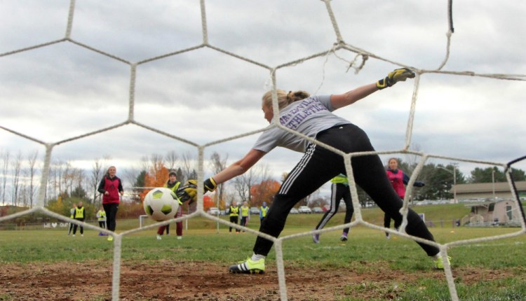 Waterville goalie TT Brandon tries to make a save during practice Monday.
