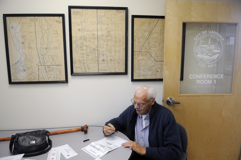 Ed Pelletier votes Tuesday at Gardiner City Hall, where City Clerk Lisa Gilliam said her office has been "swamped" by early voters.