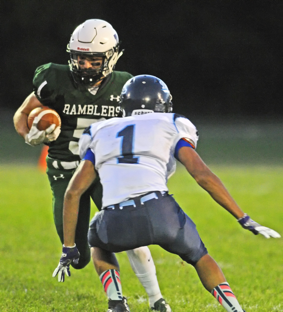 Winthrop's Nate Scott, left, tries to get around Dirigo's Hunter White during a Campbell Conference Class D game earlier this season in Winthrop. By the time the Ramblers play a playoff game, they will have had two weeks off.