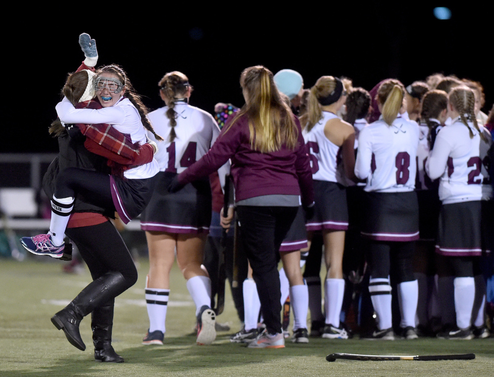 Maine Central Institute's Addi Williams jumps in to the arms of a teammate after the Huskies defeated Winthrop 3-0 for the Class C North championship Wednesday in Hampden.