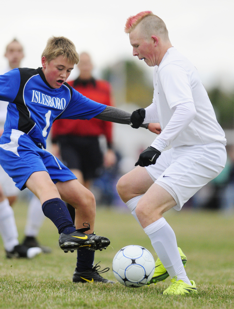 Islesboro's Elliot Anderson (1) plays defense in front of Richmond's Ethan Gardner during a Class D South semifinal game Thursday in Richmond.