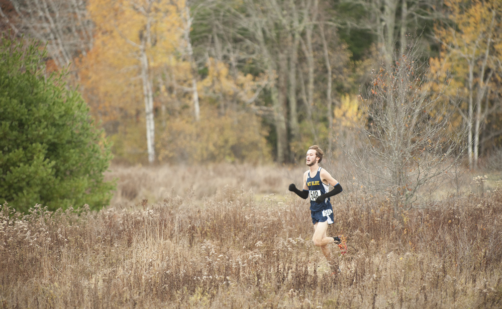 Tucker Barber, of Mt. Blue, finds himself alone as he leads with about 400 yards left in the Northern A cross country championships Saturday in Belfast.