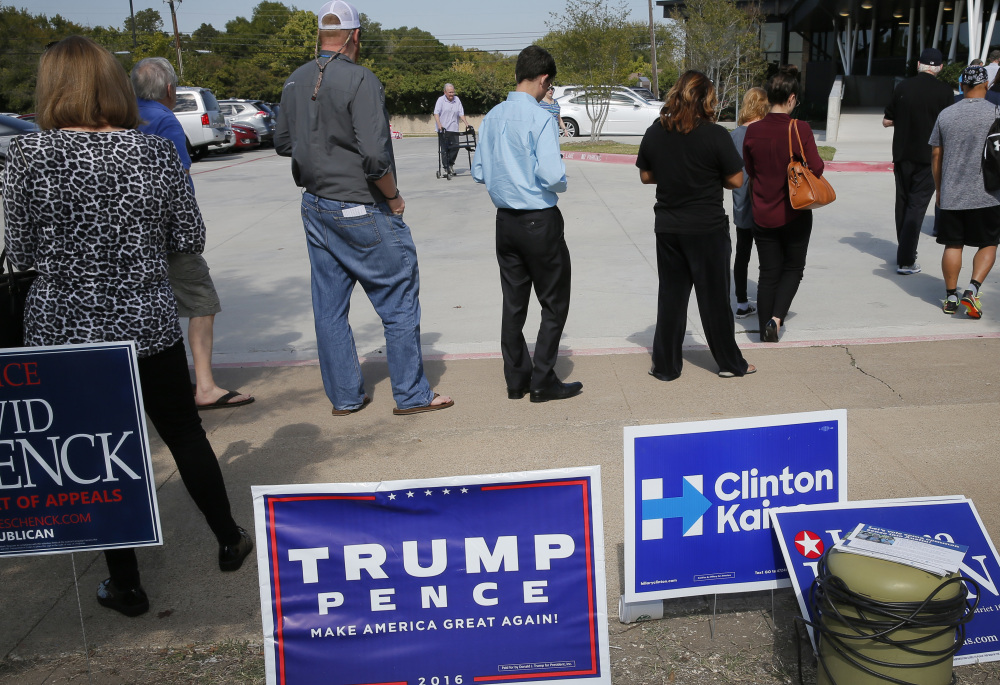 Early voters wait in line last week in Dallas. The level of early voting is in line with expectations but enthusiasm about candidates lags behind that of the 2012 election, a poll finds.