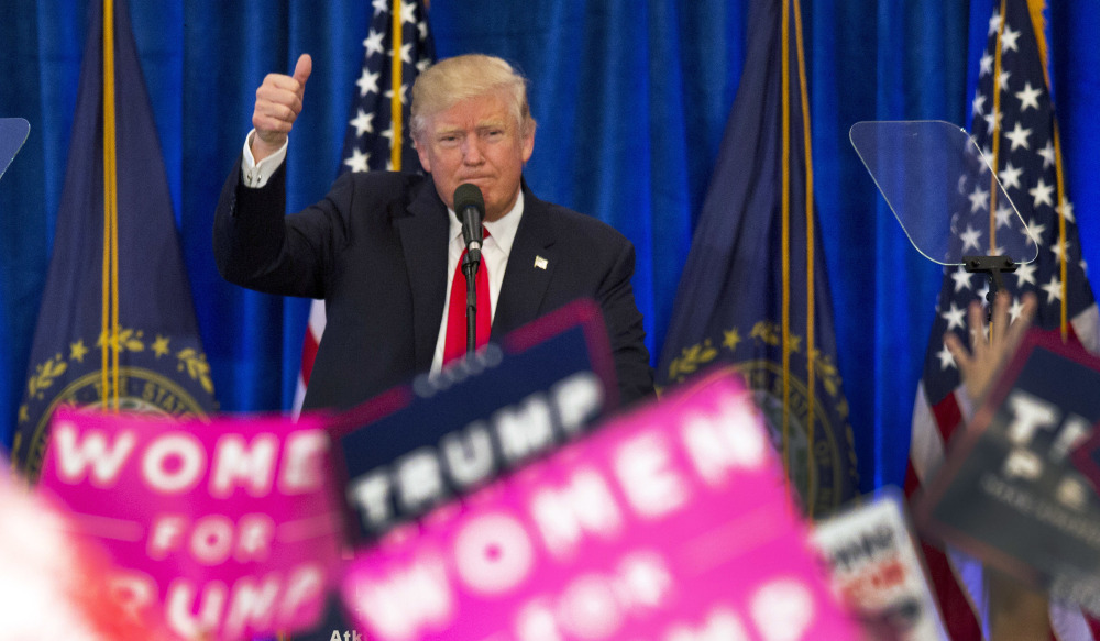 Republican presidential candidate Donald Trump gives his trademark thumbs-up to supporters during a campaign rally in Atkinson, N.H., on Friday.