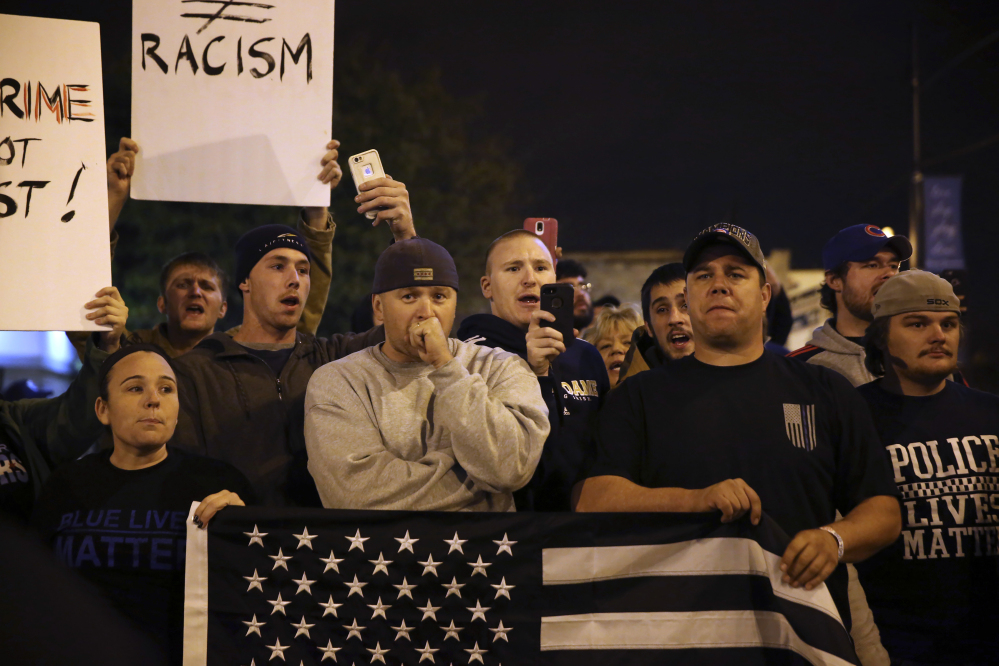 Chicago Police Department supporters watch as Black Lives Matter activists and supporters rally Tuesday in the wake of a fatal shooting in the Mount Greenwood neighborhood.Chicago.