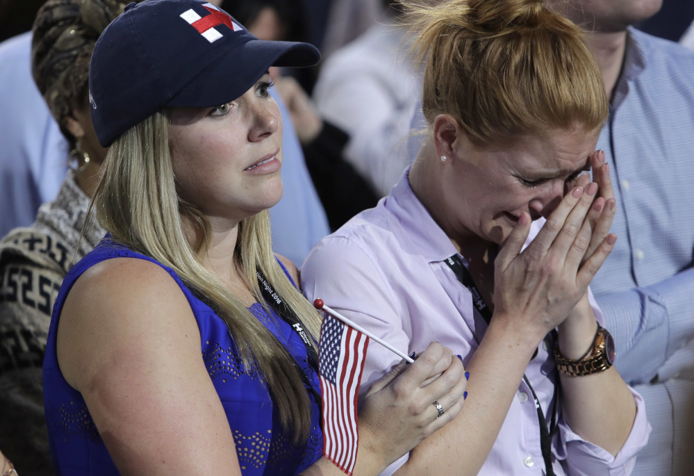 A woman weeps as election results are announced during Hillary Clinton's election night rally in the Jacob Javits Center glass-enclosed lobby in New York.