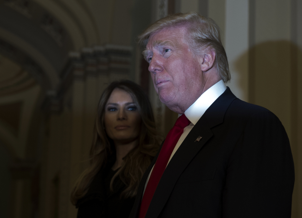 President-elect Donald Trump, accompanied by his wife, Melania, speaks to the media on Capitol Hill in Washington on Thursday.