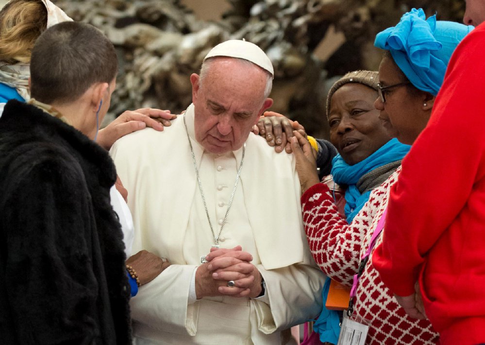 Pope Francis is greeted by the faithful during an audience with the participants of the homeless jubilee Friday at the Vatican.