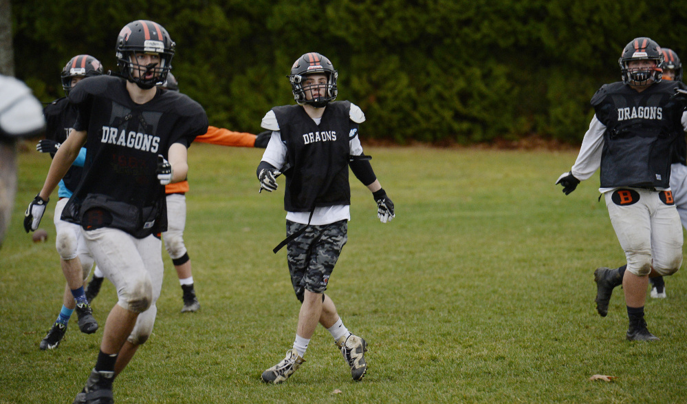 Jesse Devereaux, right, rarely comes off the field for Brunswick, not only anchoring the defense but rushing for 741 yards and 10 touchdowns this season.