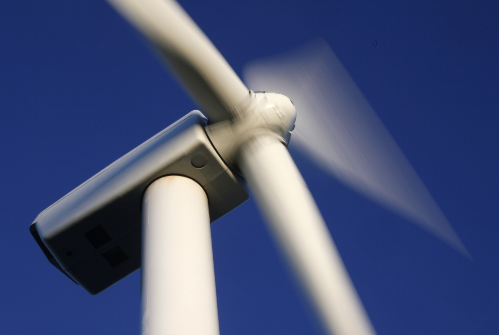 This July 2009 photo shows the blades of a turbine on Stetson Mountain in eastern Maine. The state has several clean-energy projects in the works, including solar arrays and wind farms.