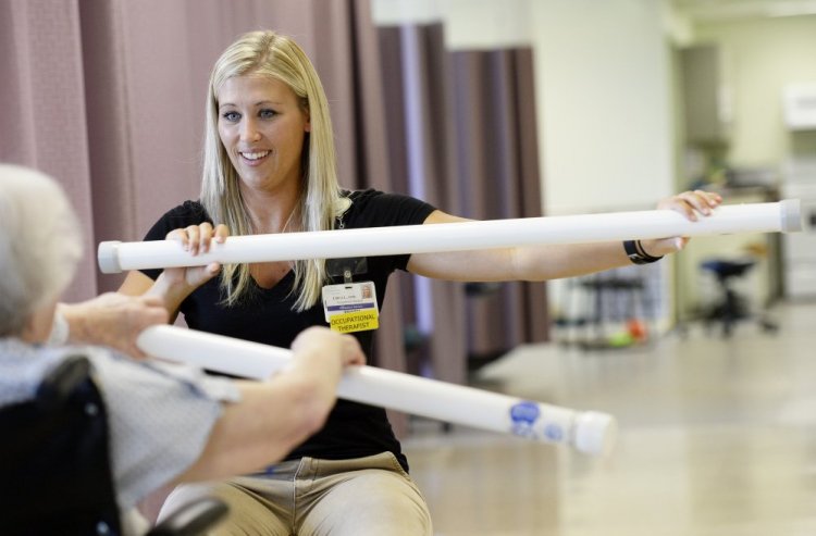 Erica Lyford, an occupational therapist at Mayo Regional Hospital in Dover-Foxcroft, works with a patient. Mayo and other rural care facilities are increasingly relying on rehab and other outpatient services as revenue from inpatient health care plummets.